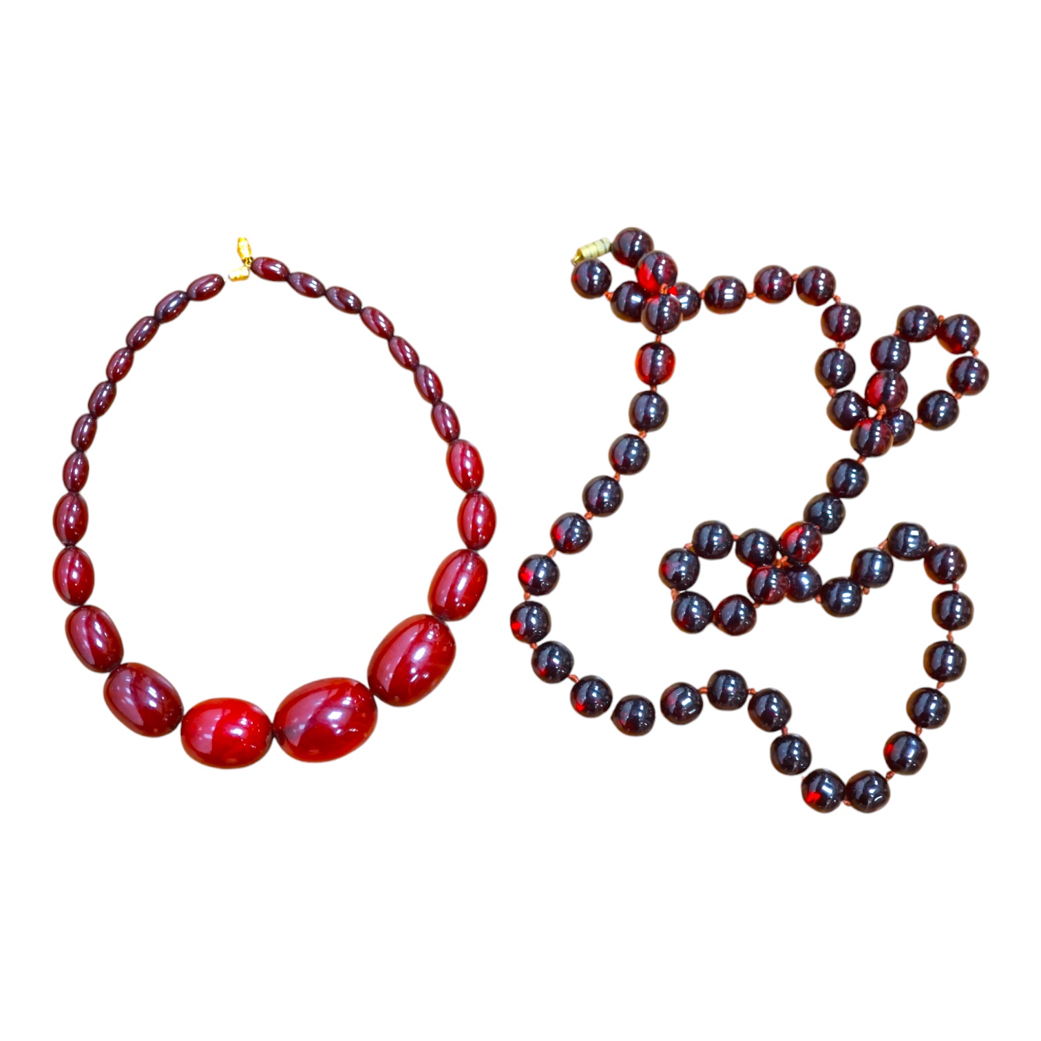 Two single strand simulated cherry amber bead necklaces, including one graduated string, 38cm, gross weight 173 grams. Condition - fair